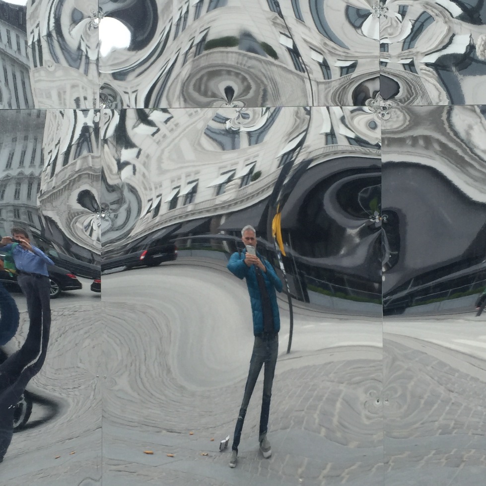 Man reflected in distorted image in mirror, Copenhagen, Denmark
